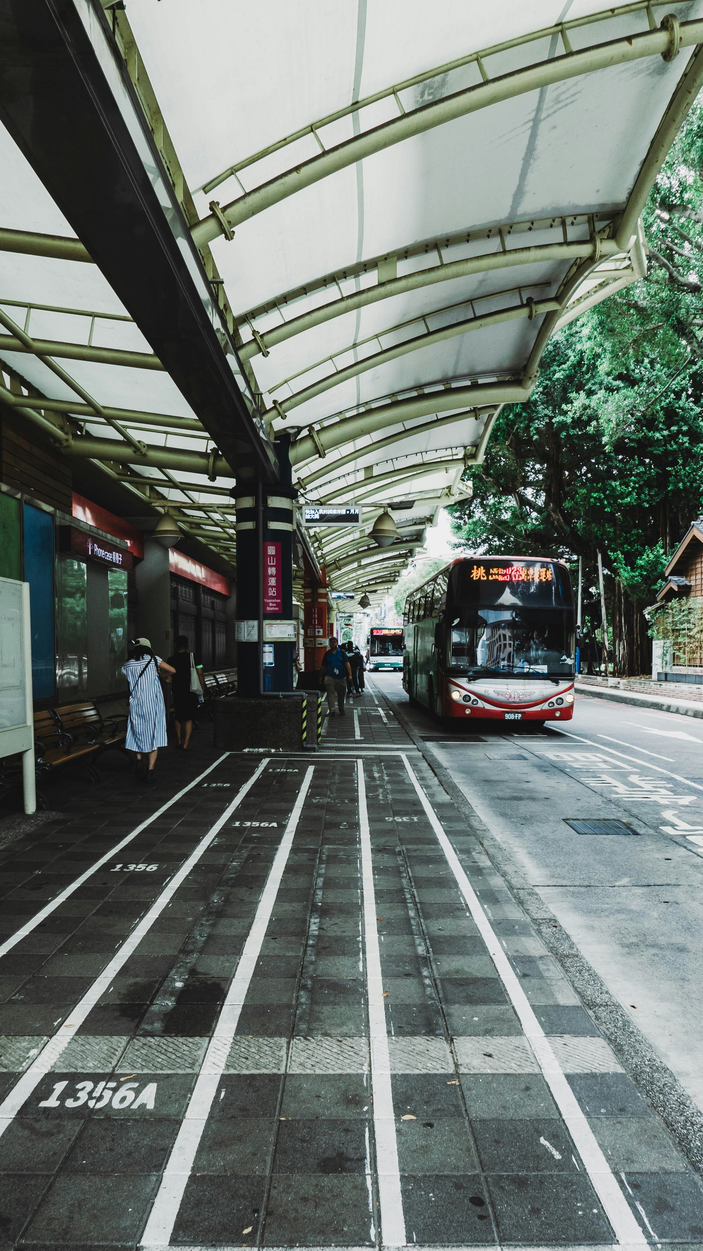 A bus station with a bus parked next to it