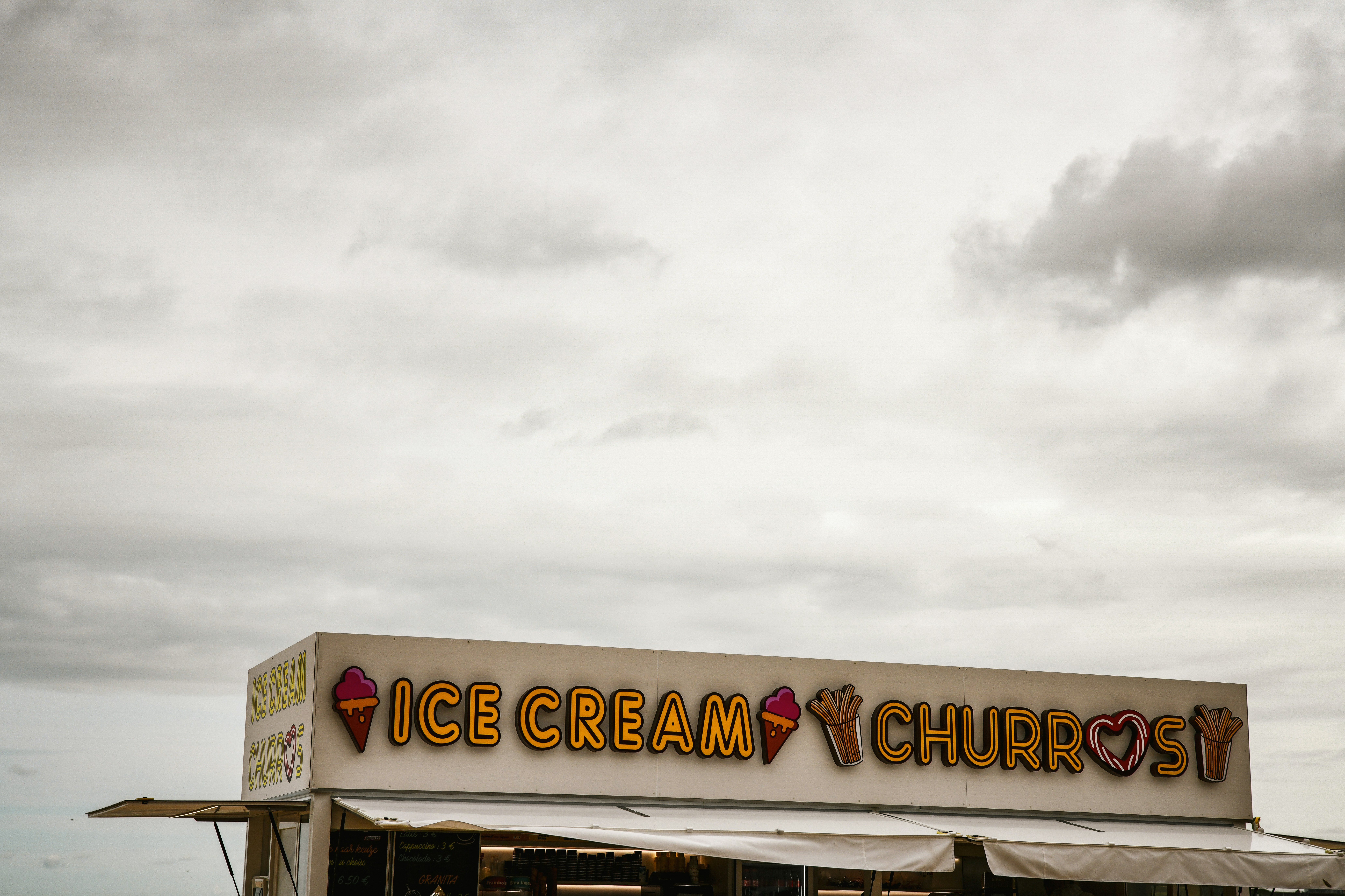 A small ice cream shop sitting on the side of a road