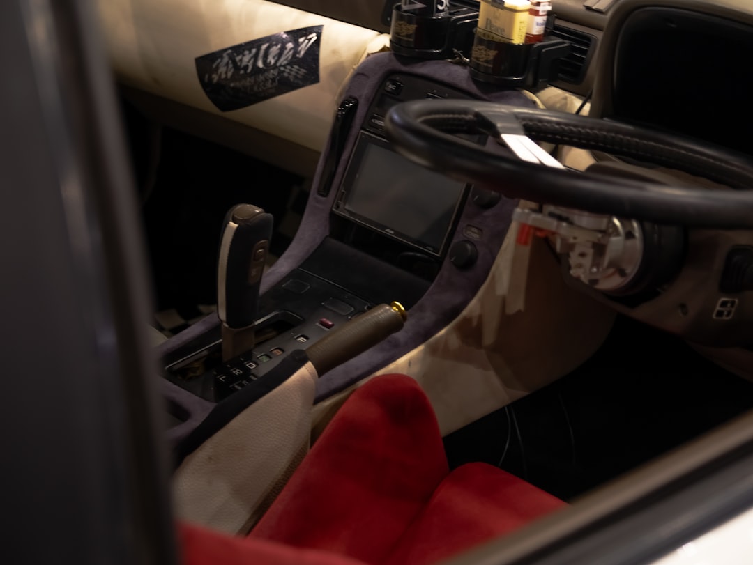 A car dashboard with a steering wheel and dashboard lights,