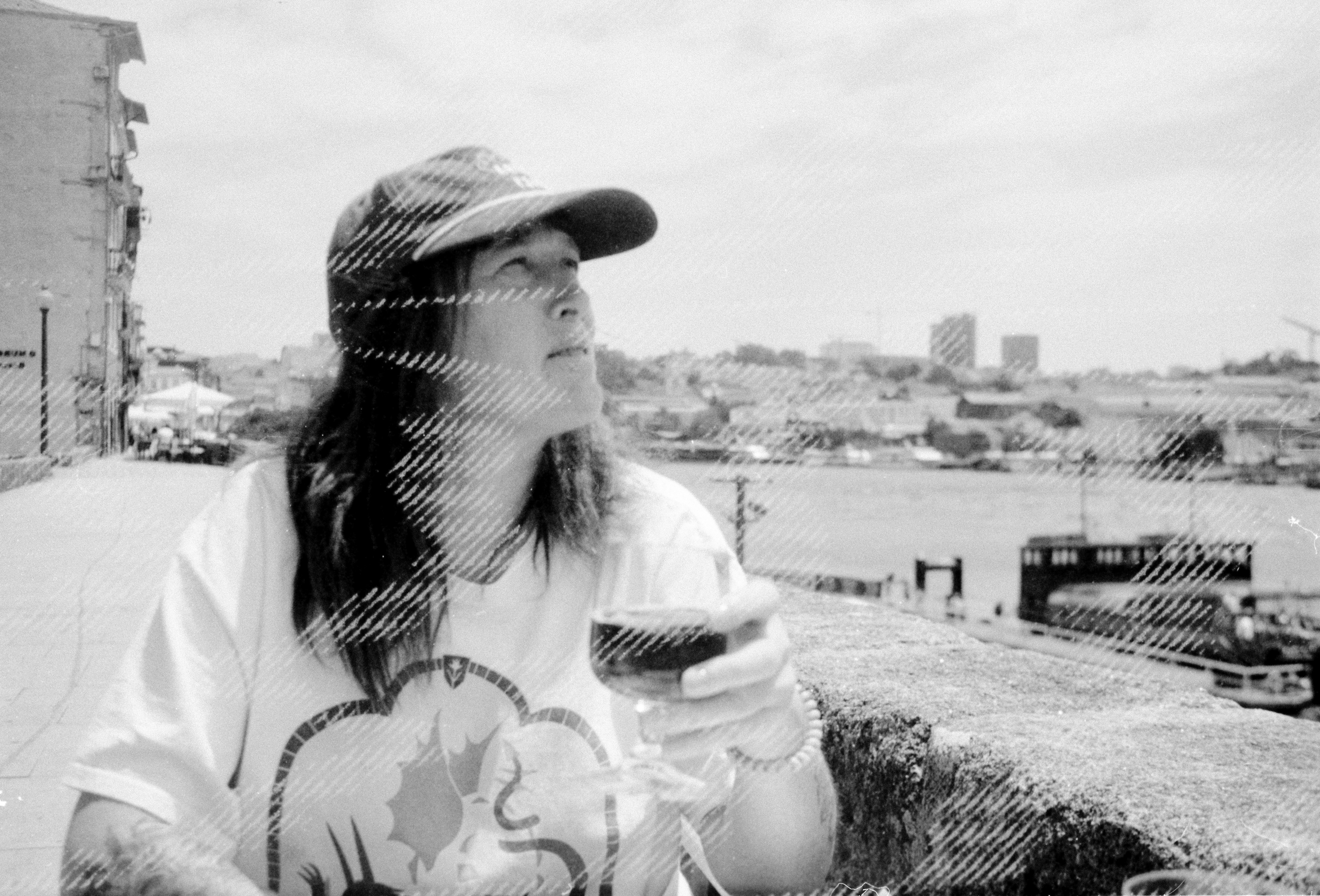 A woman sitting at a table with a glass of wine