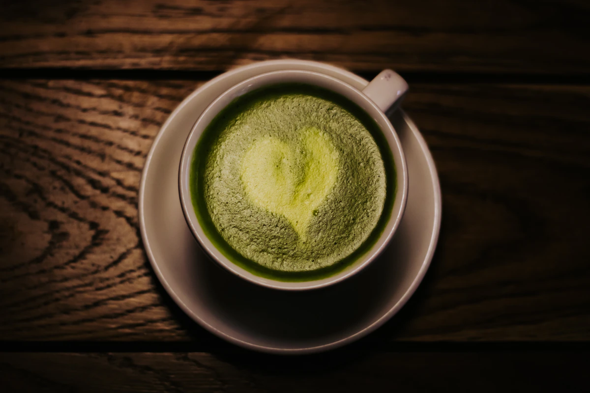 Fresh green matcha served in a ceramic cup on a wooden table