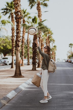 A woman holding a frisbee on the side of a road
