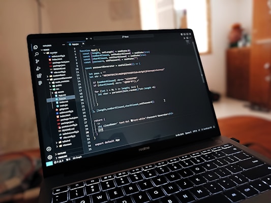 A laptop computer sitting on top of a wooden desk