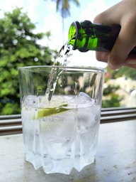 A person is pouring water into a glass