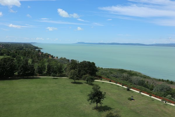 The lake from a park on the north shore — An aerial view of a green field with a lake in the background