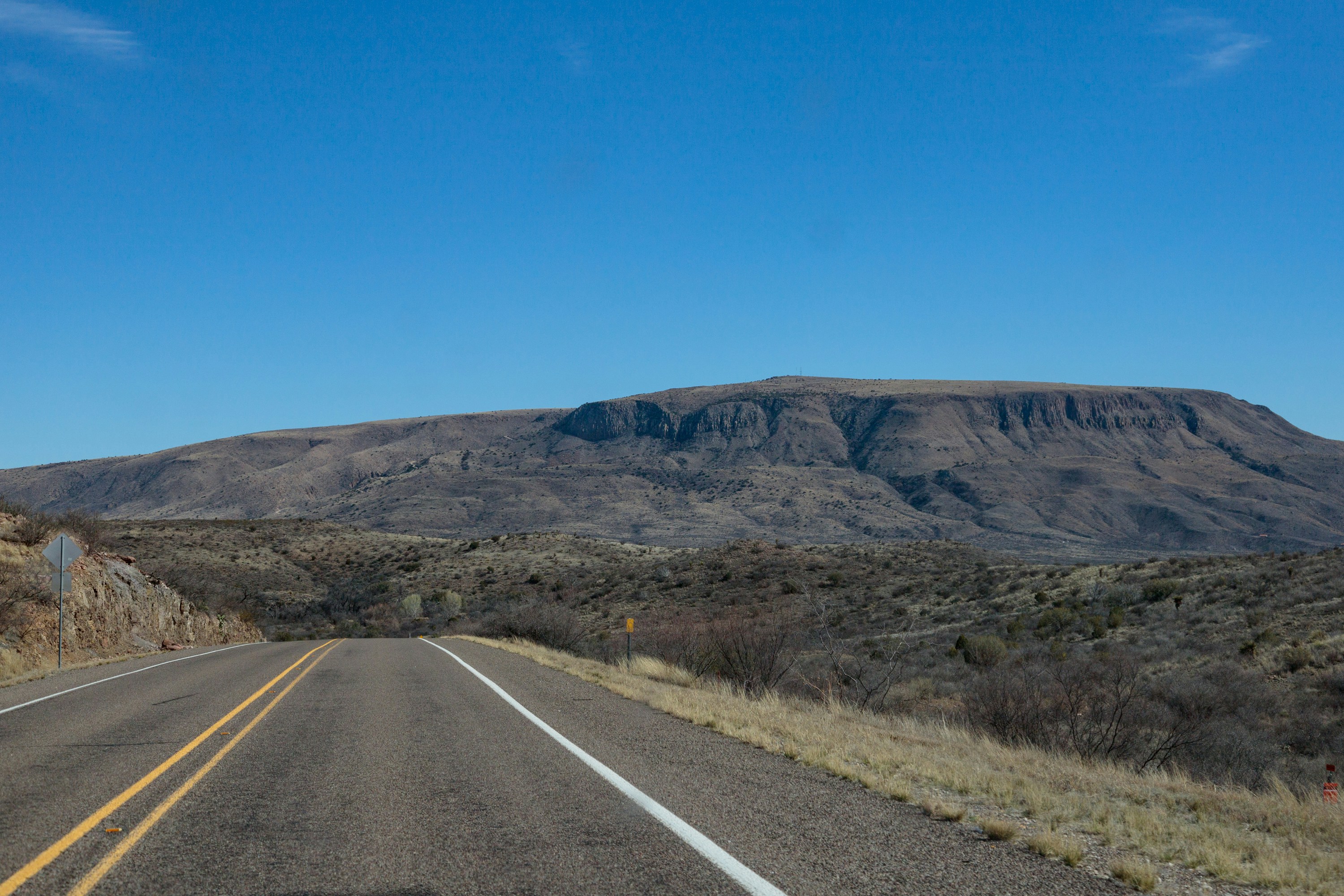 A road with a mountain in the background