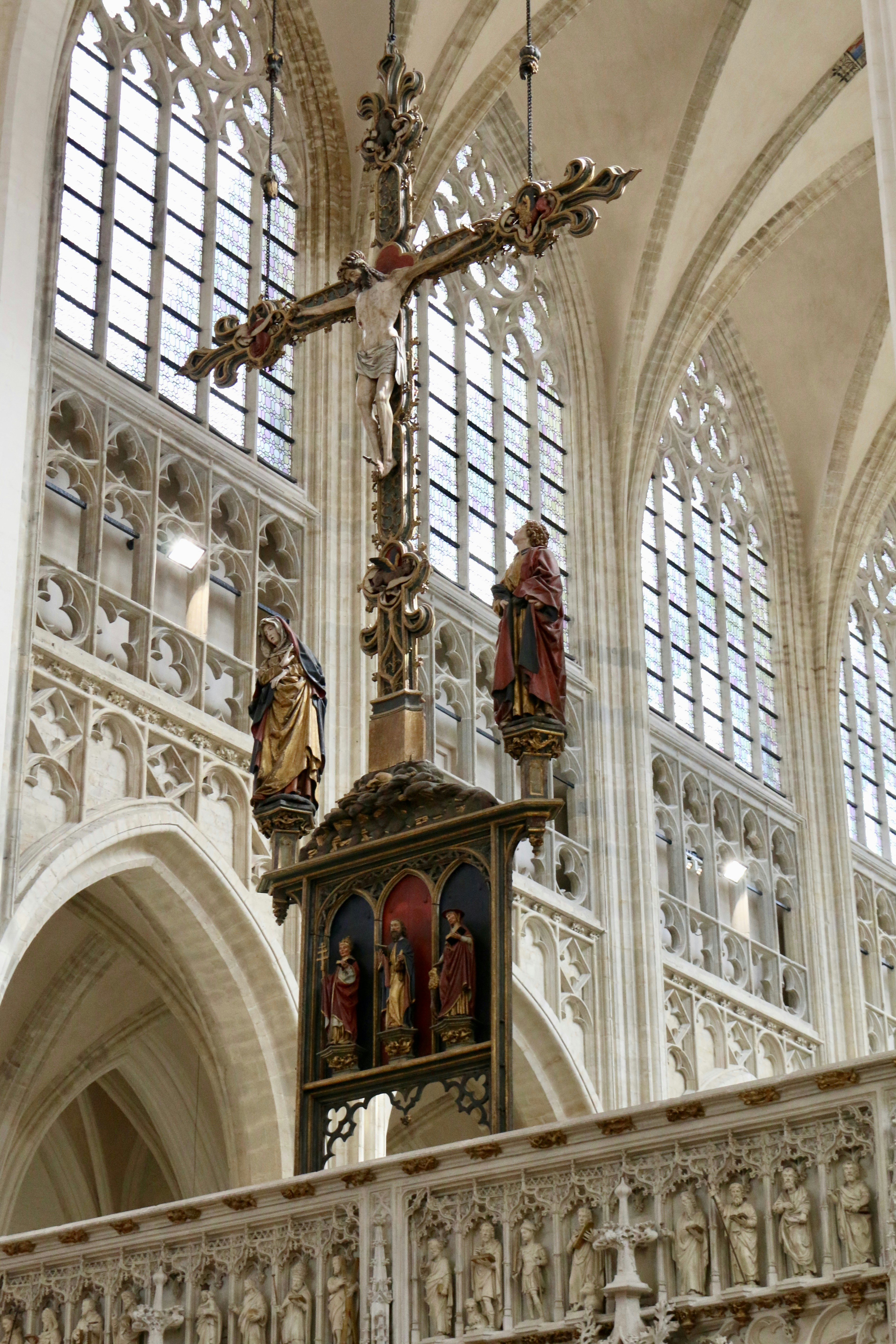 A church with a cross and statues on the alter