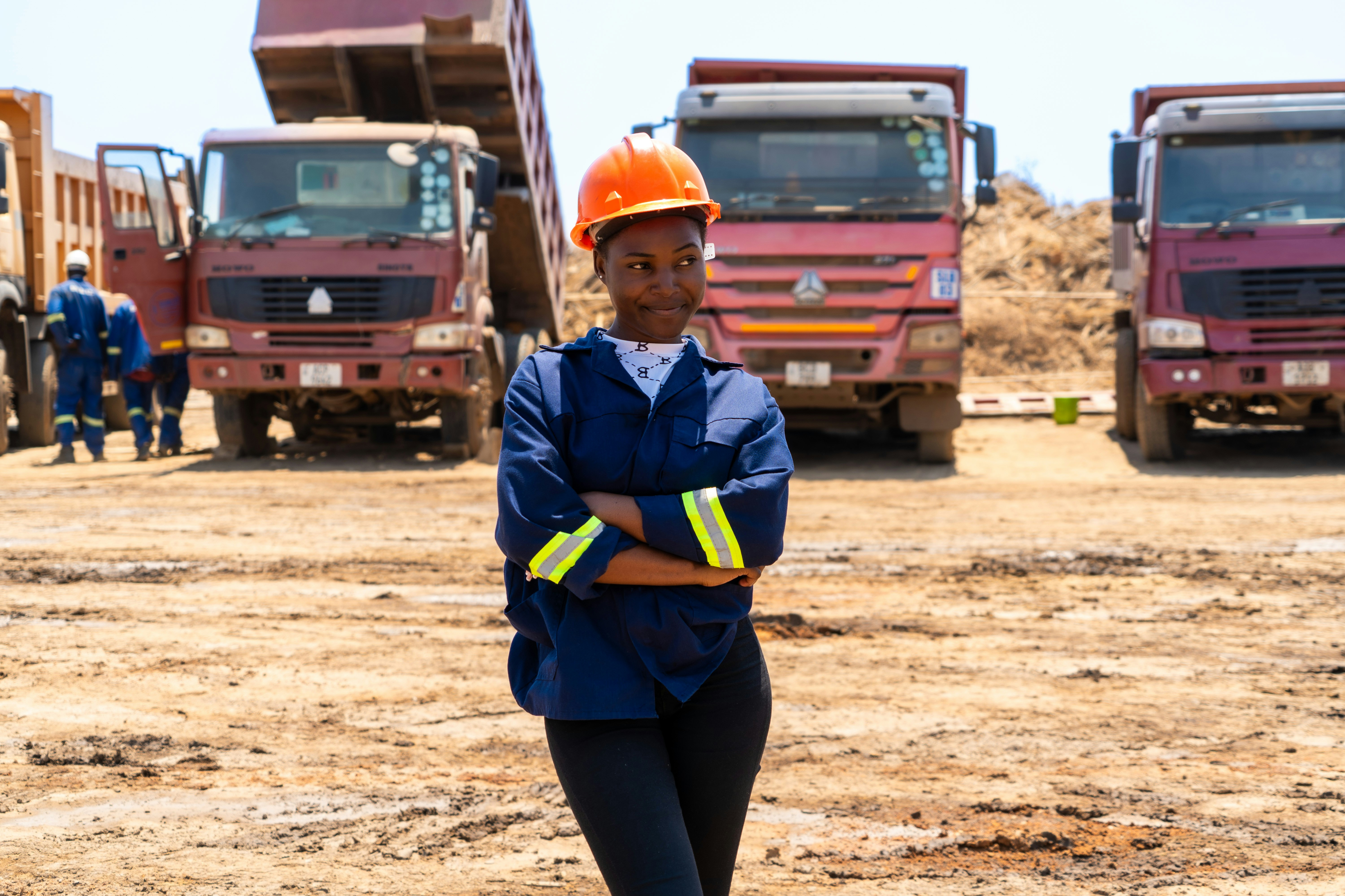 A woman standing in front of a group of trucks