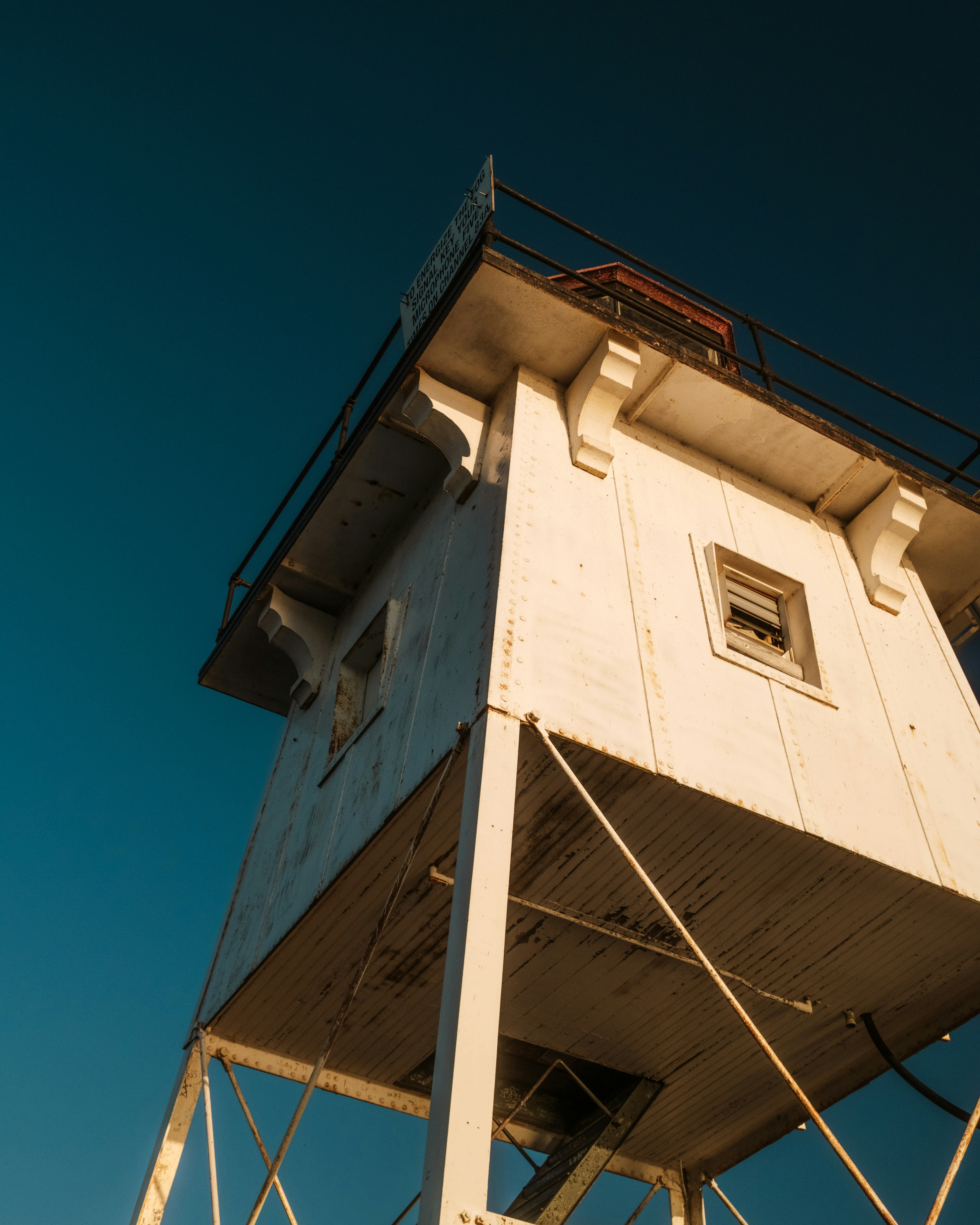 A tall white tower with a sky background