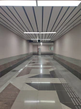 A long hallway with a tiled floor and ceiling