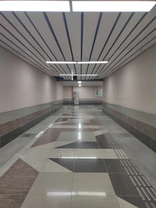 A long hallway with a tiled floor and ceiling