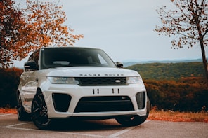 A white range rover parked in a parking lot