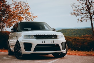 A white range rover parked in a parking lot
