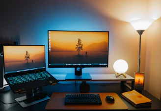 A computer desk with two monitors and a keyboard