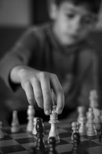 A young boy playing a game of chess