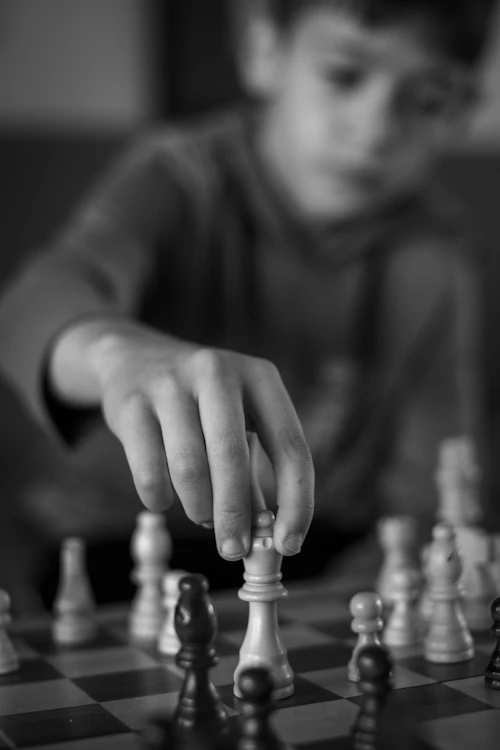 A young boy playing chess