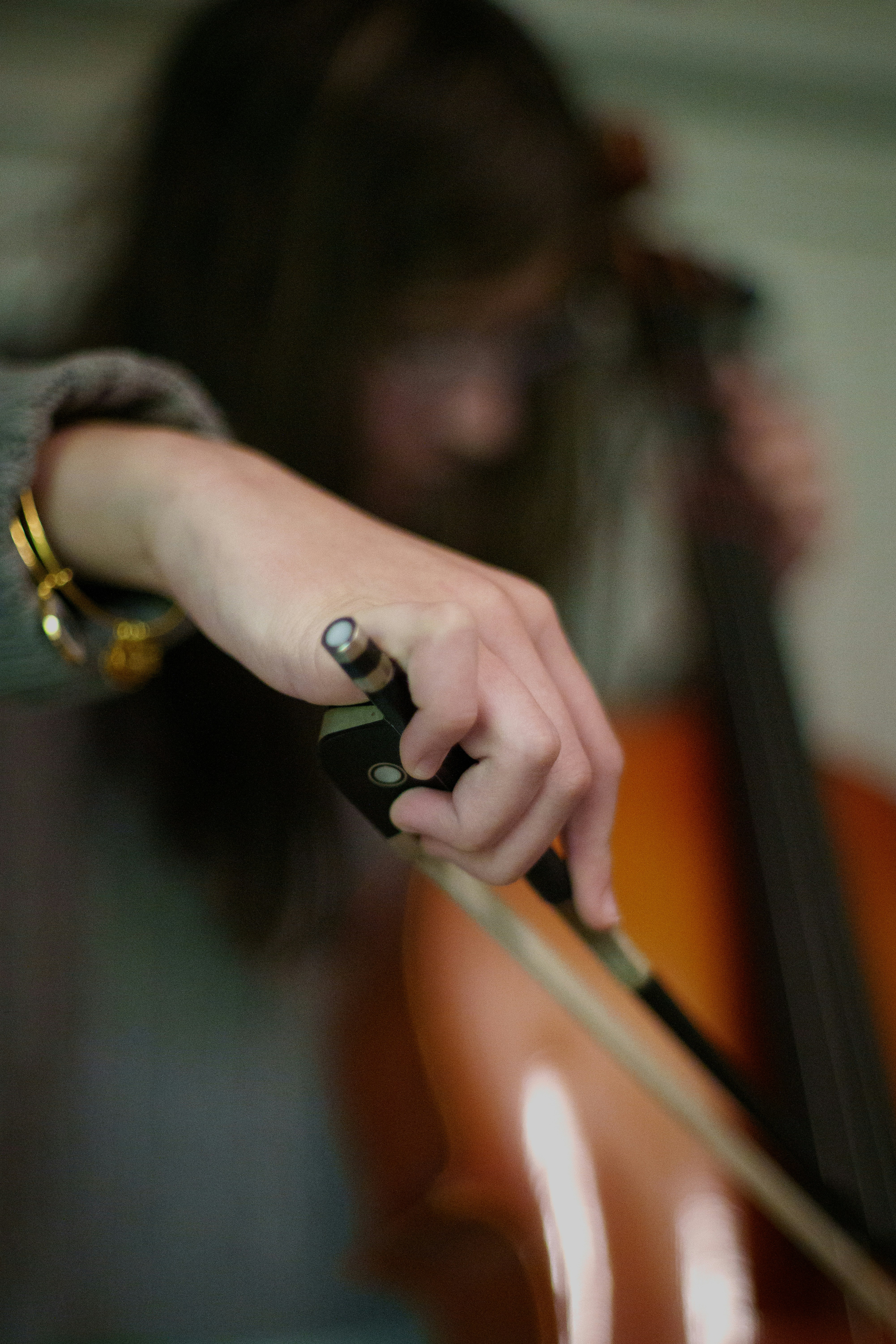 A close up of a person playing a cello