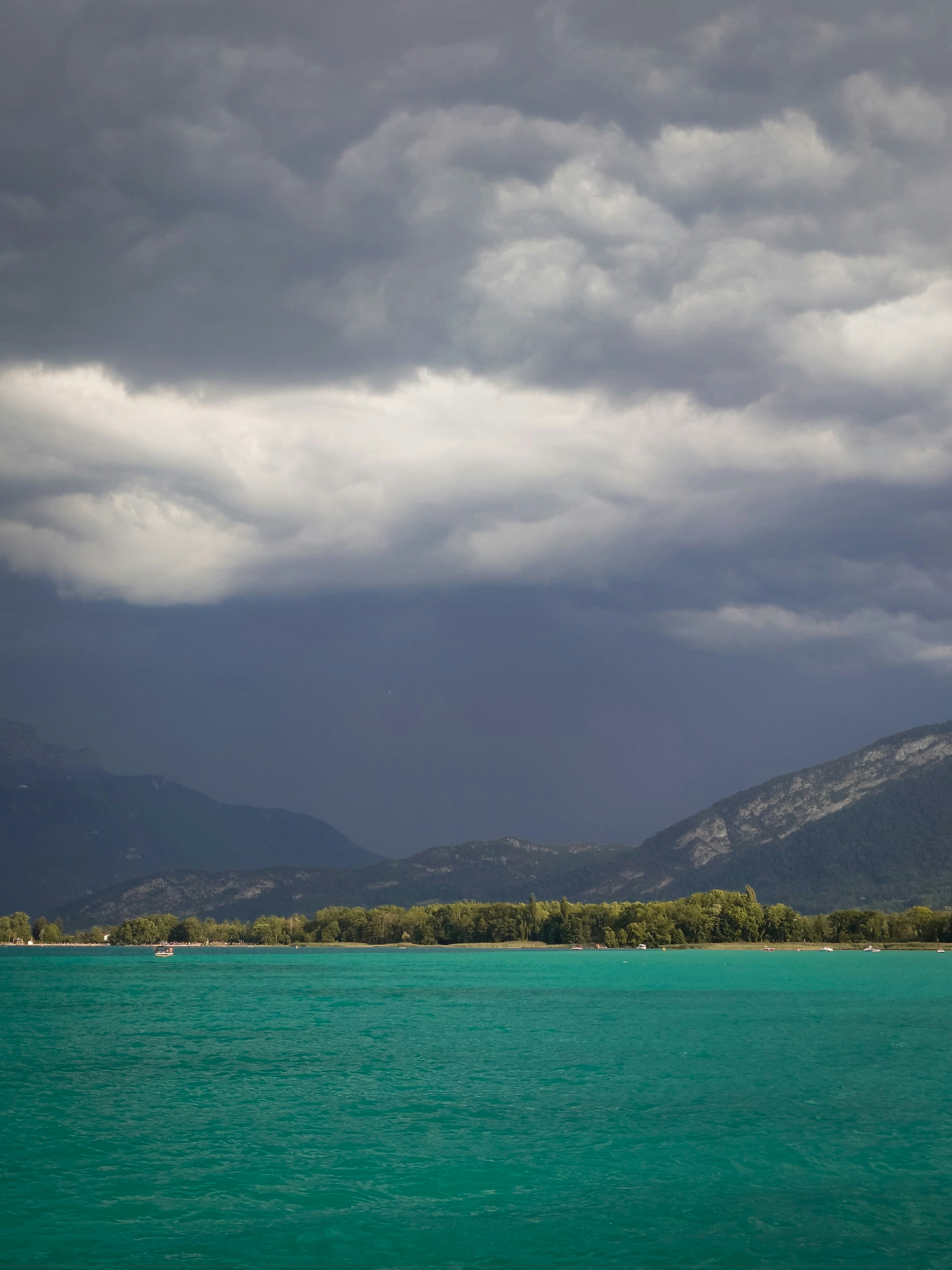 A large body of water under a cloudy sky