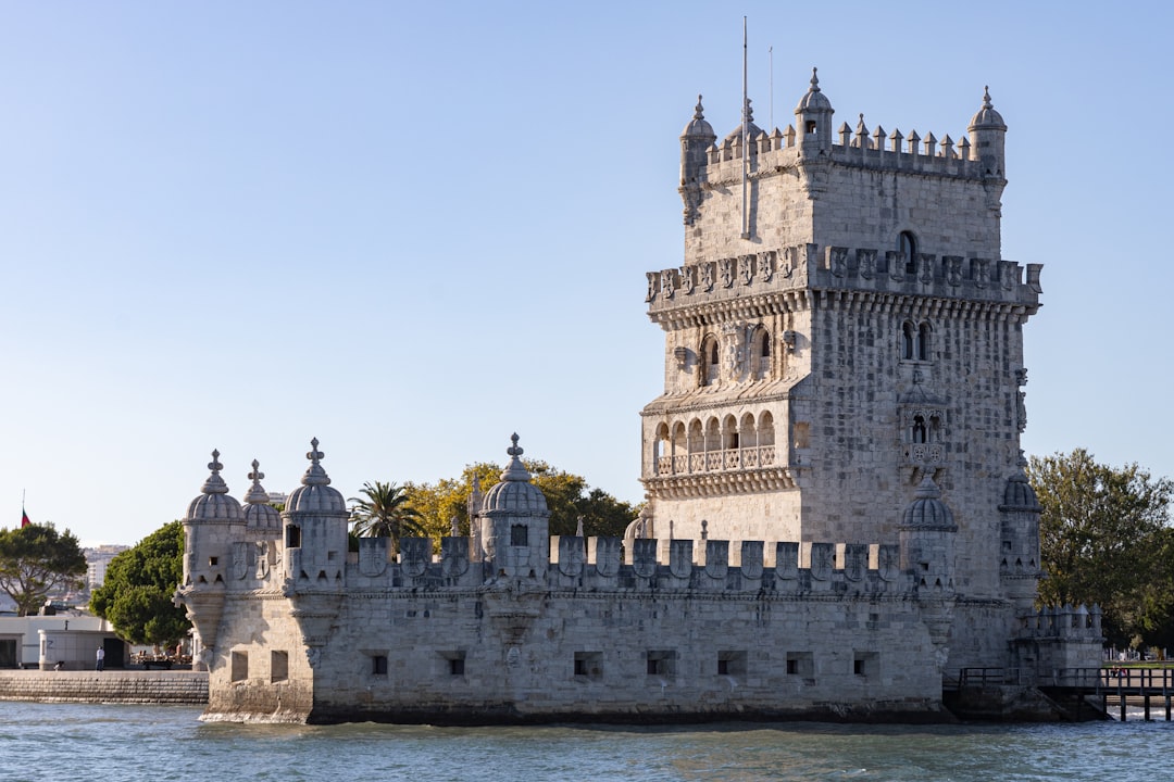 A castle like structure sitting on top of a body of water,