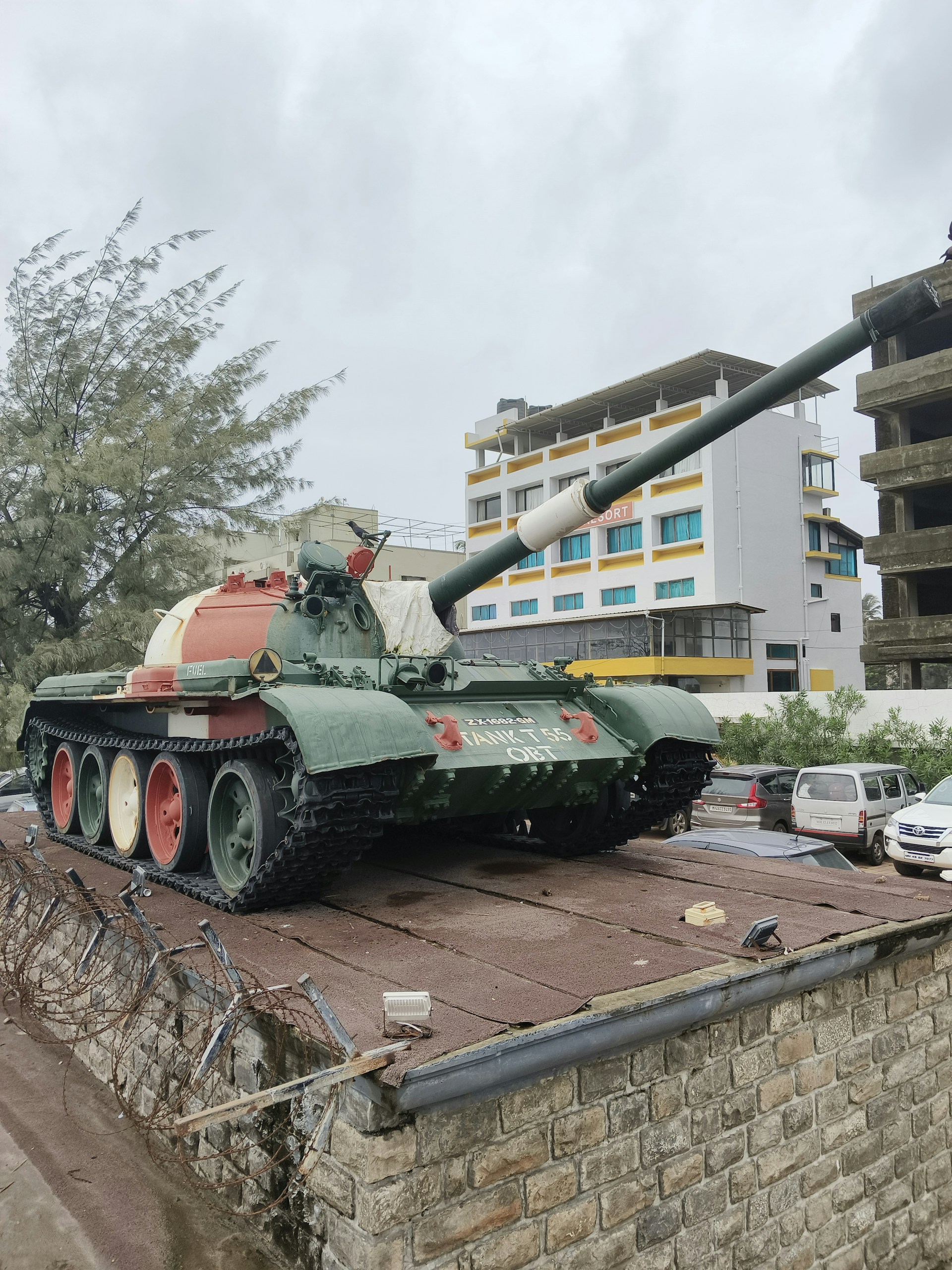 A tank sitting on top of a brick wall