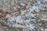 A pile of trash sitting on top of a sandy beach