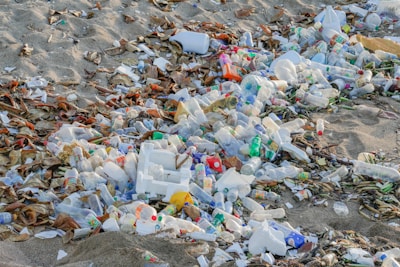 A pile of trash sitting on top of a sandy beach