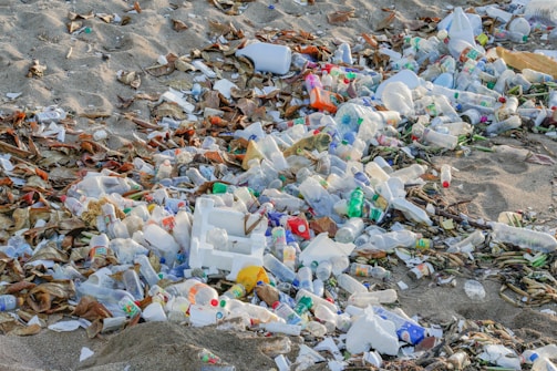 A pile of trash sitting on top of a sandy beach