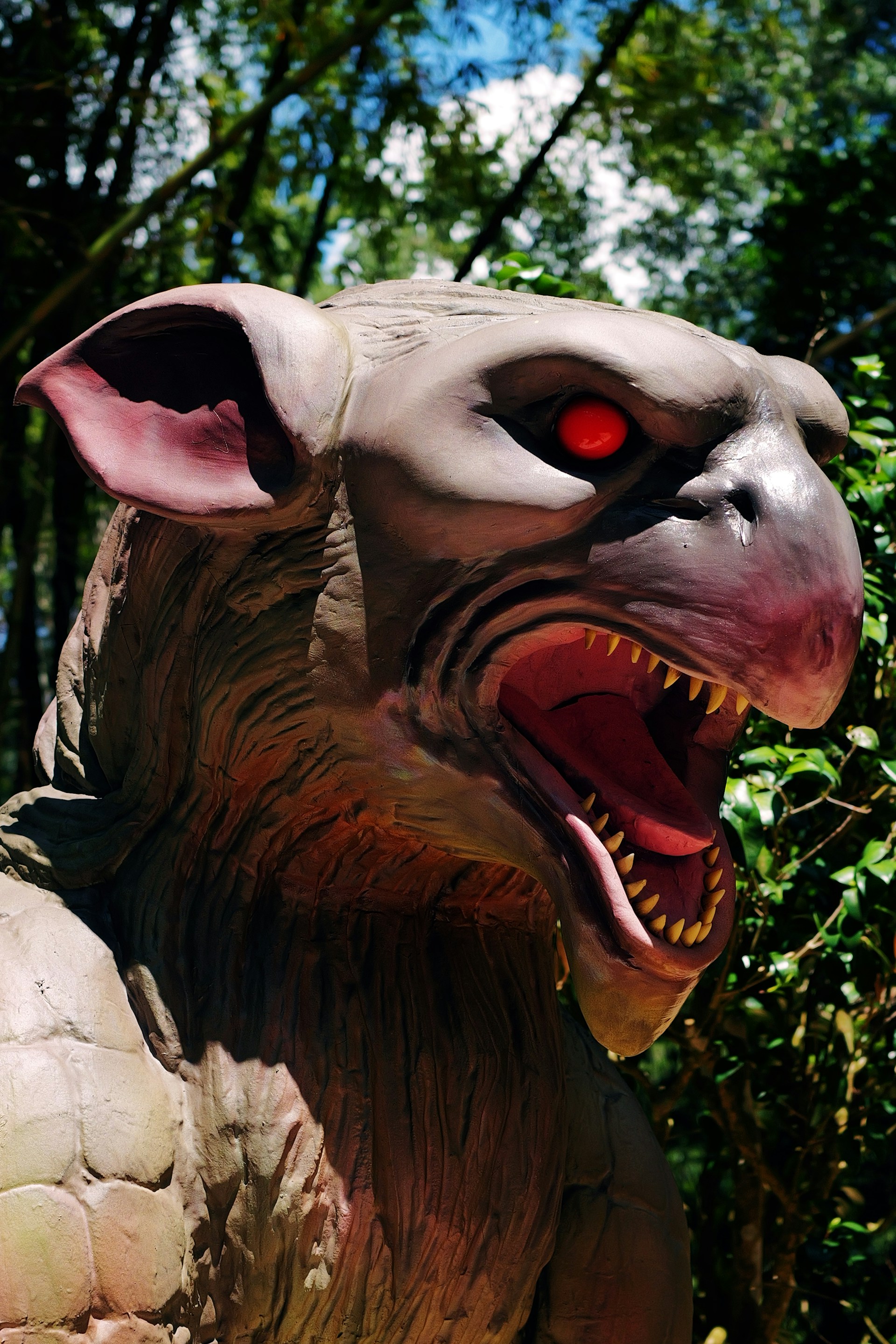 A close up of a statue of a creature with red eyes