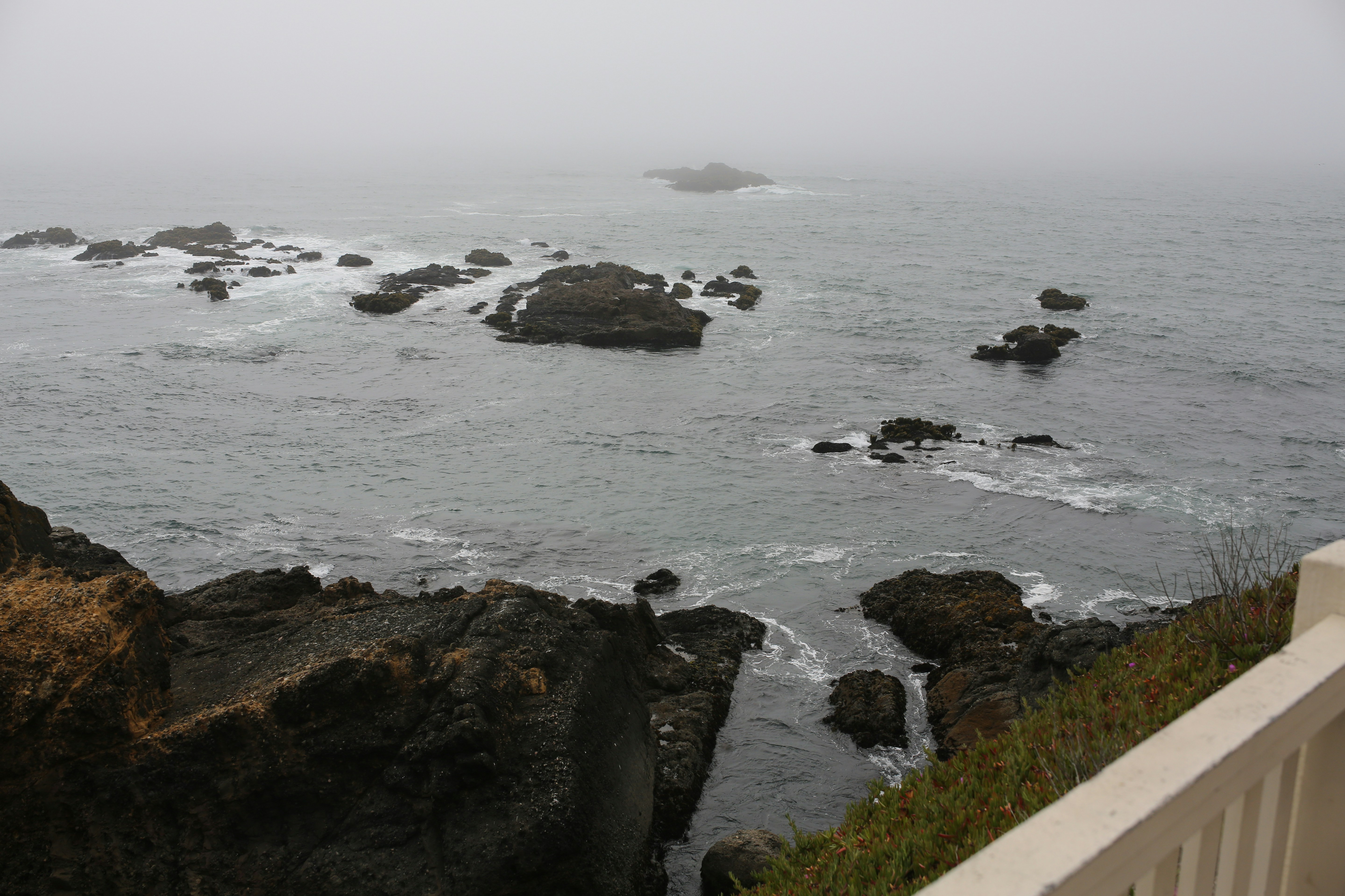 A view of a body of water with rocks in the foreground