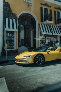 A yellow sports car parked in front of a building
