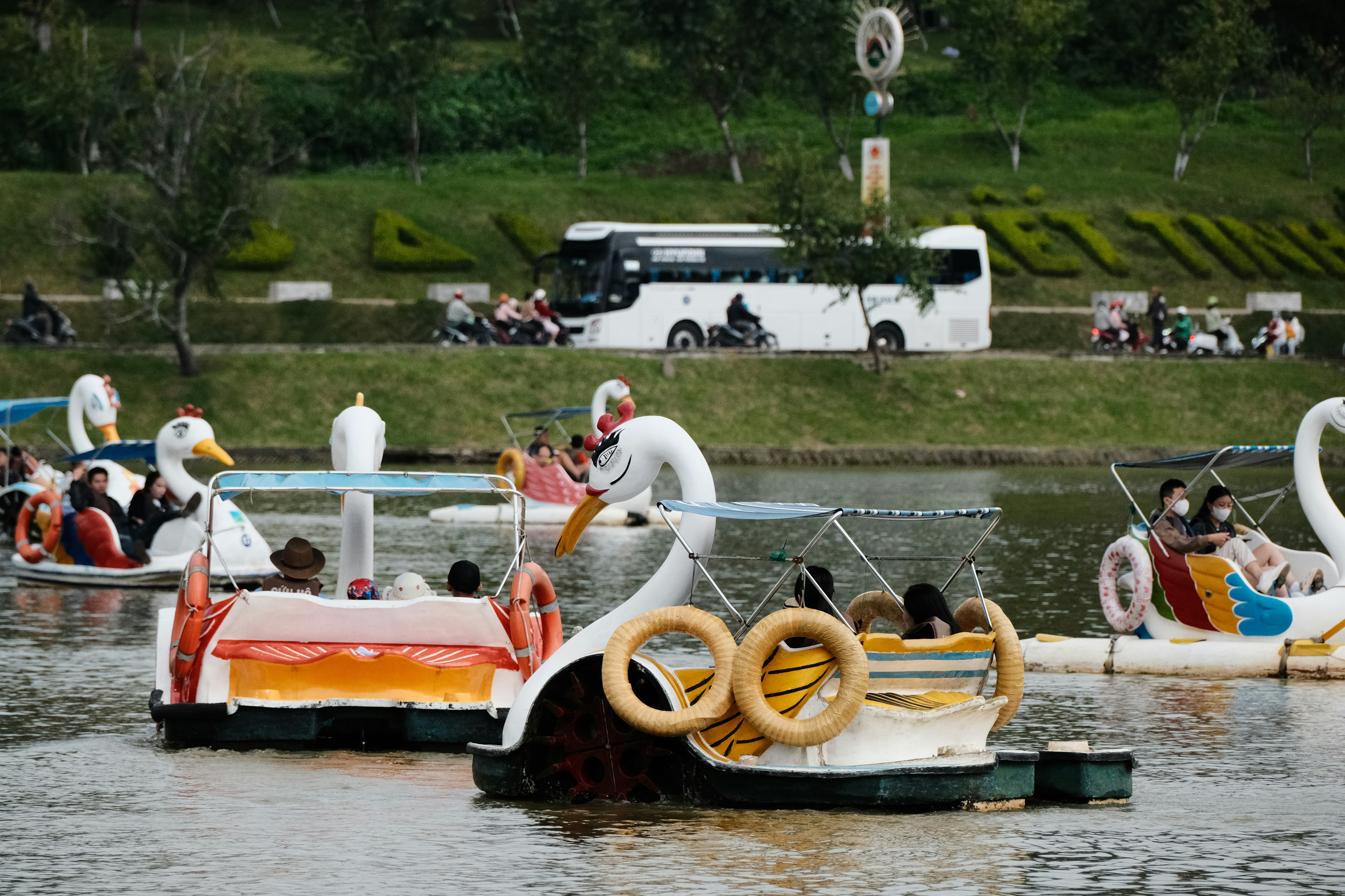 A group of people riding on top of a boat in a body of water photo ...