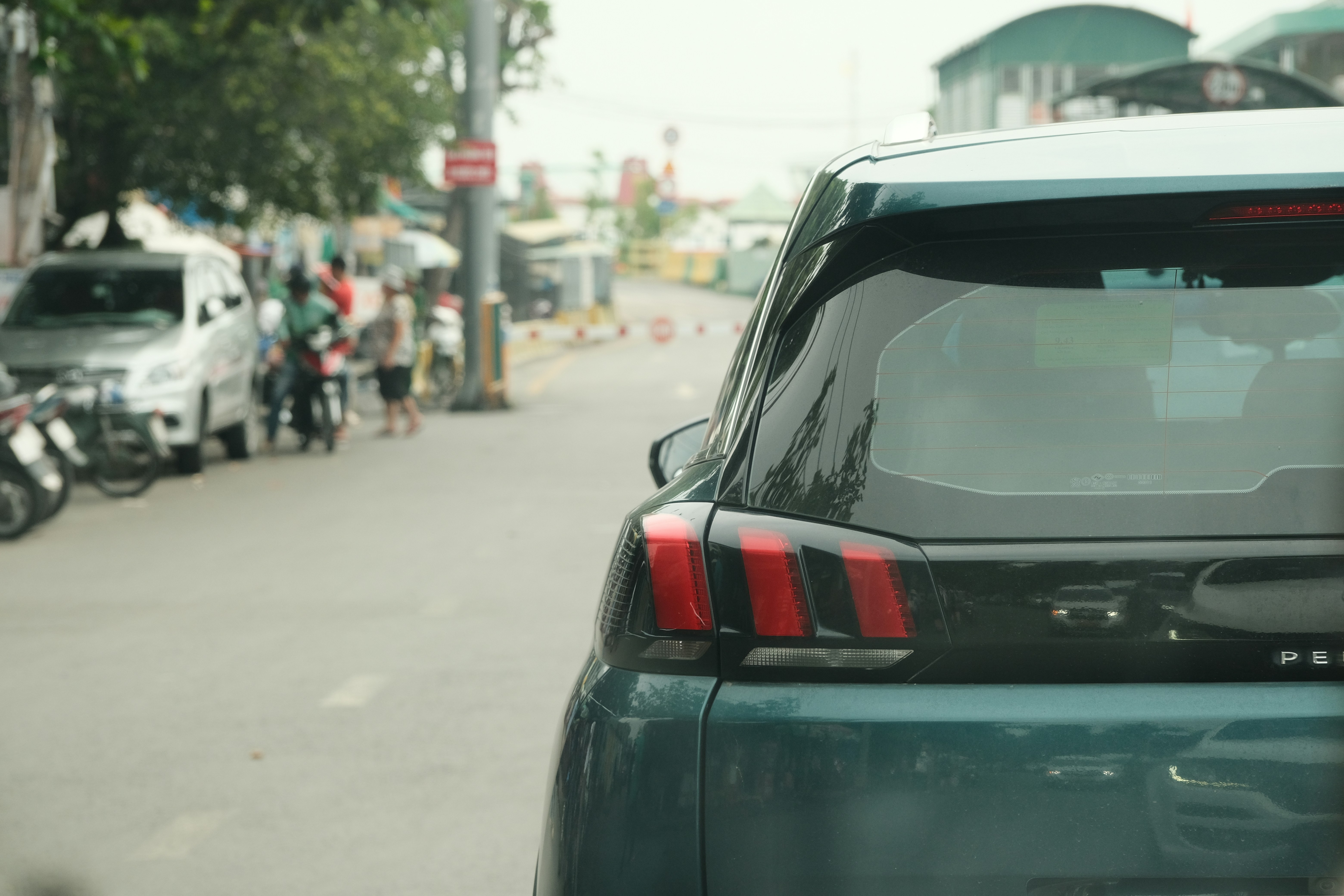 A blurry photo of a car parked on the side of the road