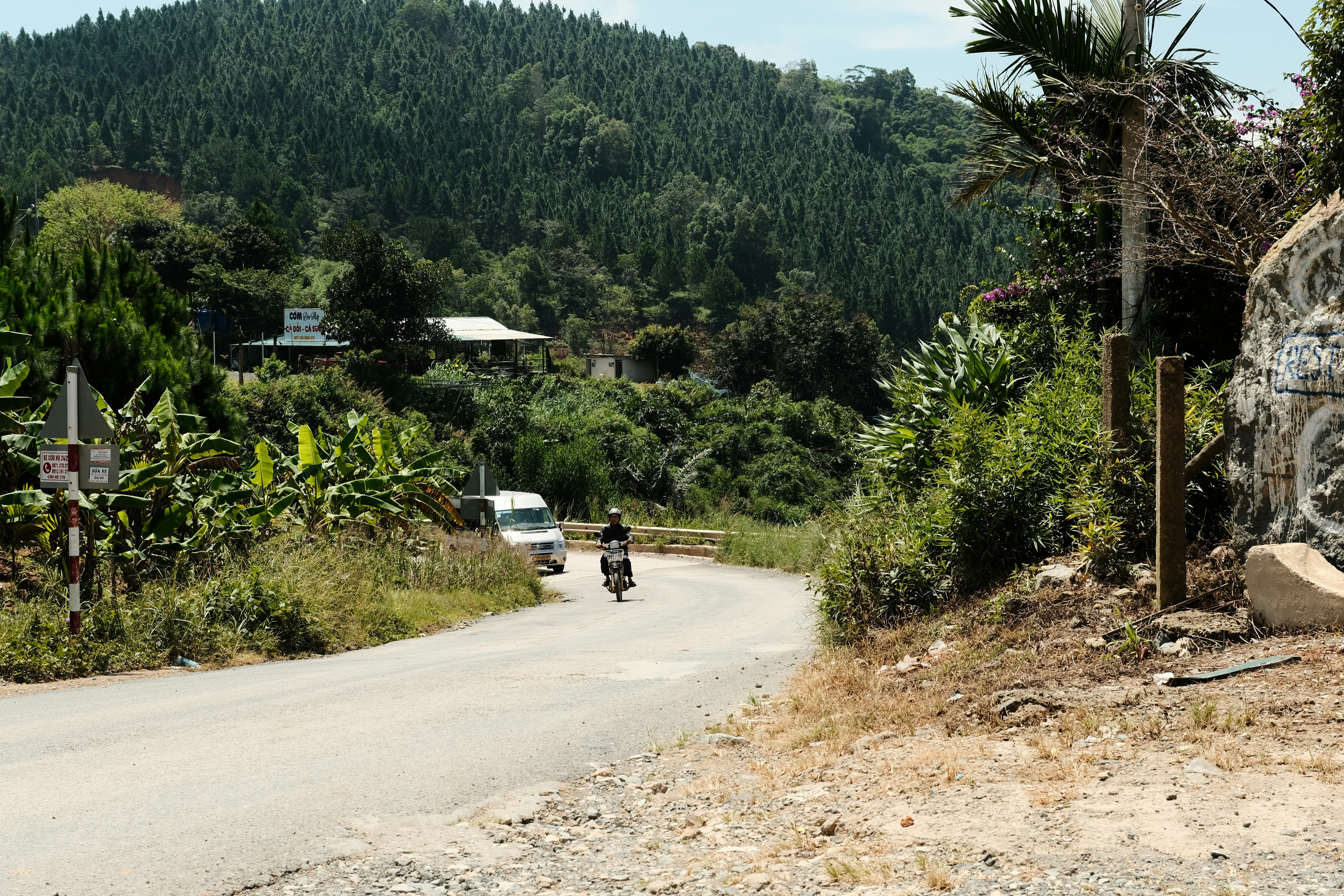 A man riding a motorcycle down a dirt road