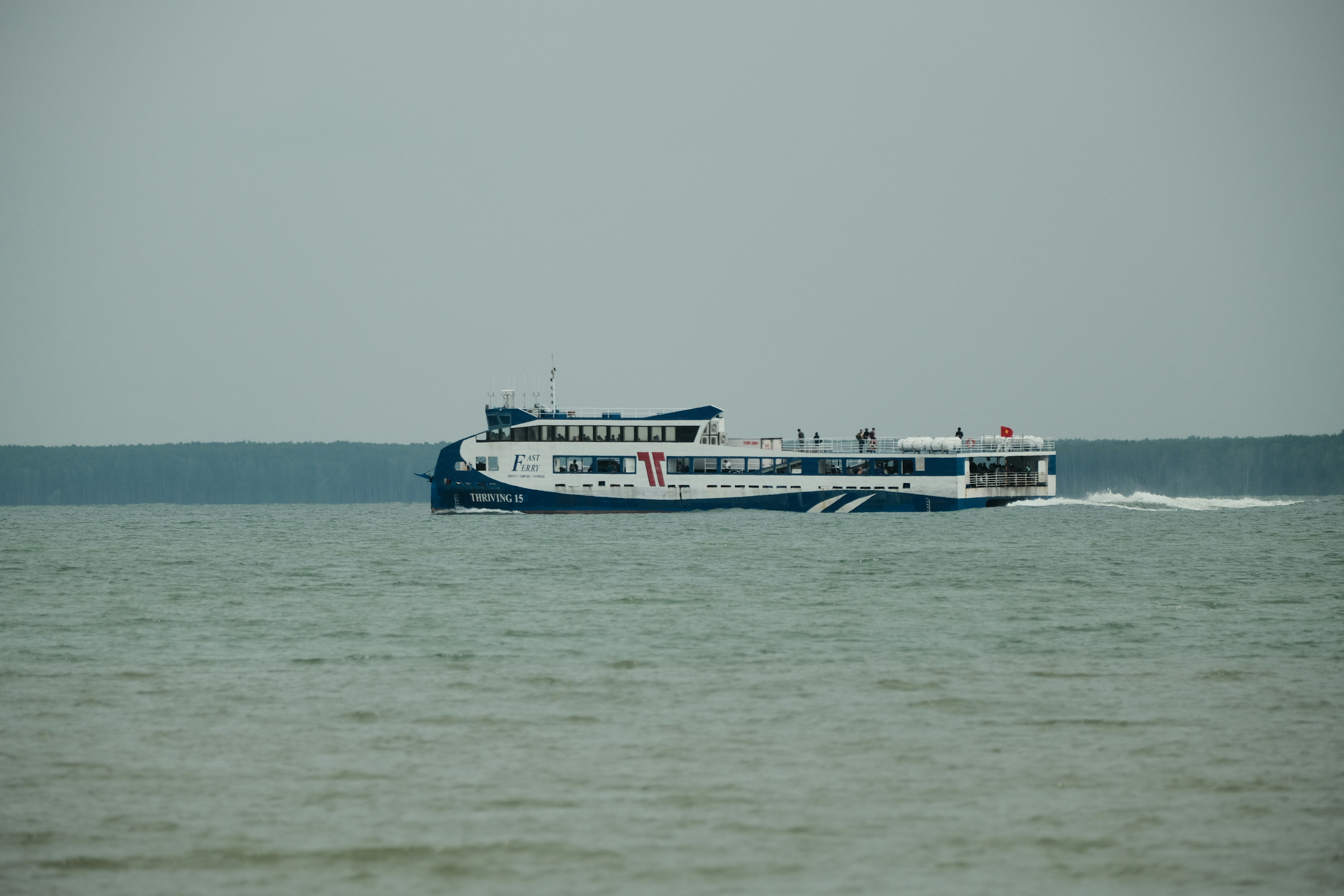 A large boat traveling across a large body of water, 