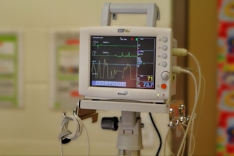 A hospital room with a monitor on a tripod