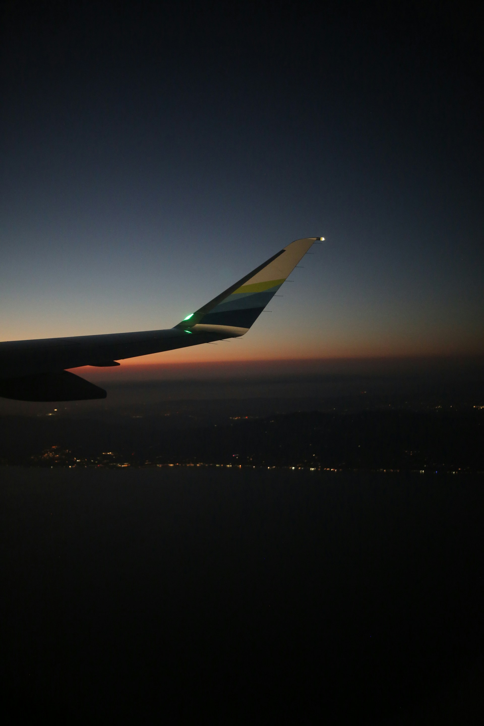 A view of the wing of an airplane at night