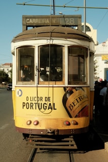 A yellow trolley car on a city street