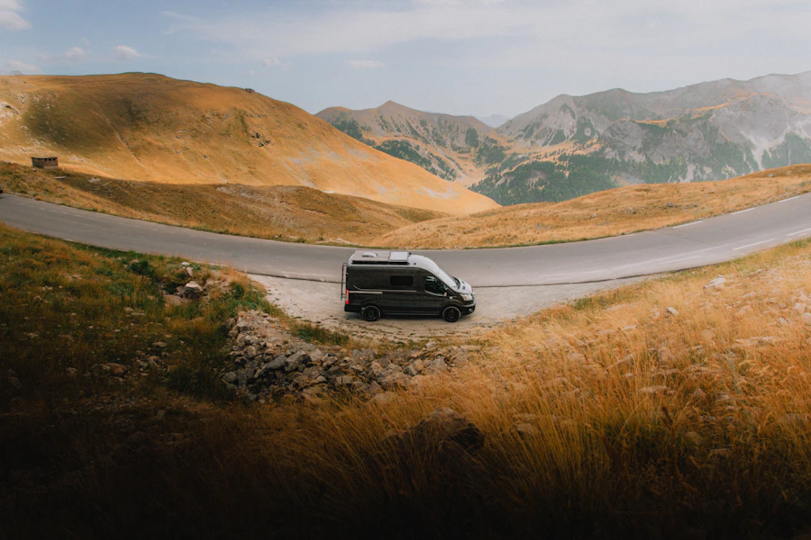 A campervan on a winding single-track mountain road