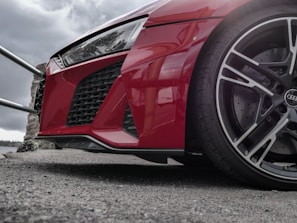 A red car parked on the side of a road