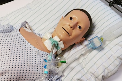 A dummy is laying in a hospital bed