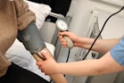A person with a blood pressure device in their hand