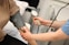 A person with a blood pressure device in their hand