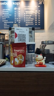 A coffee shop counter with a menu behind it