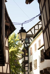 A narrow street with a lamp hanging from it's side