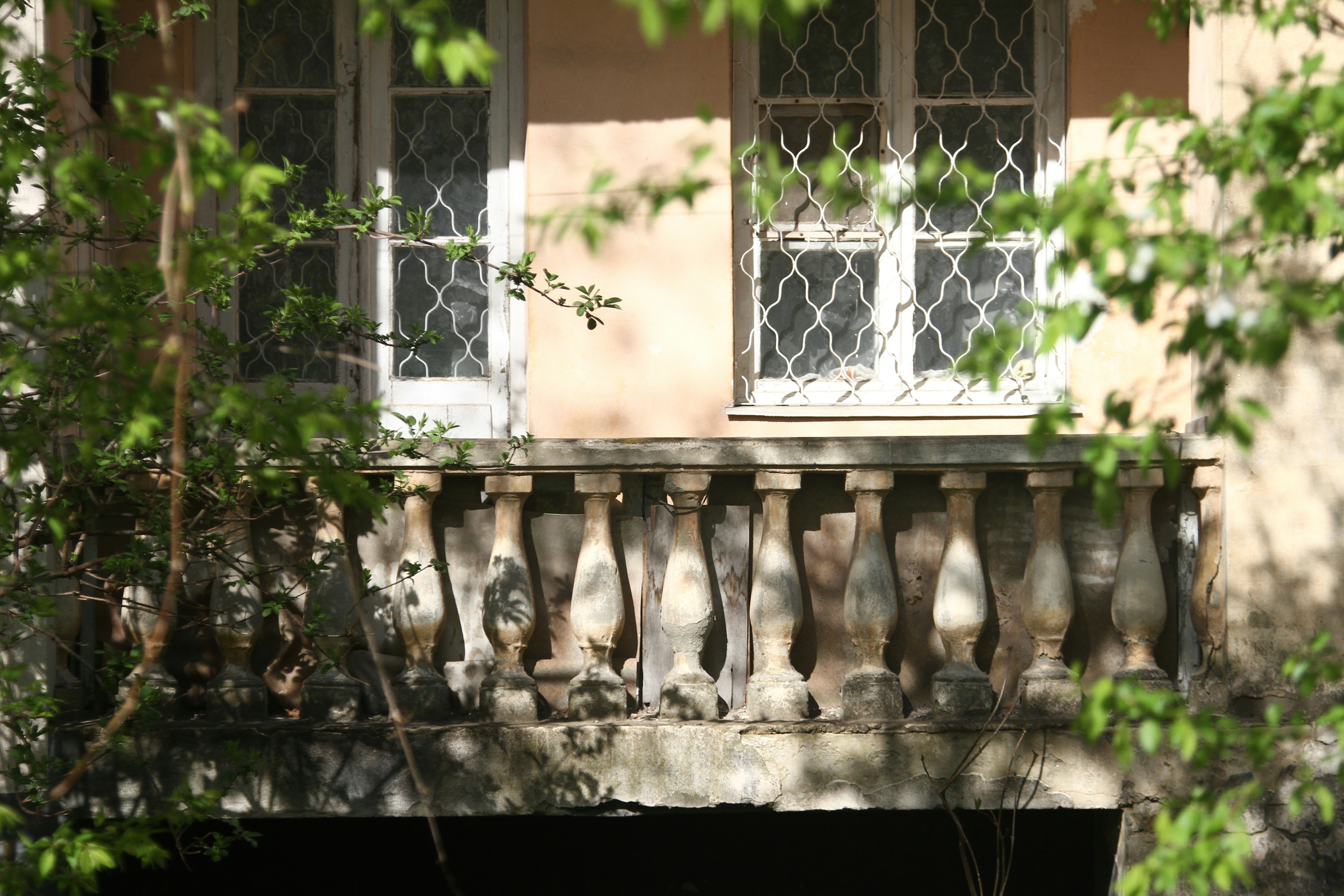 A building with a balcony and a clock on it