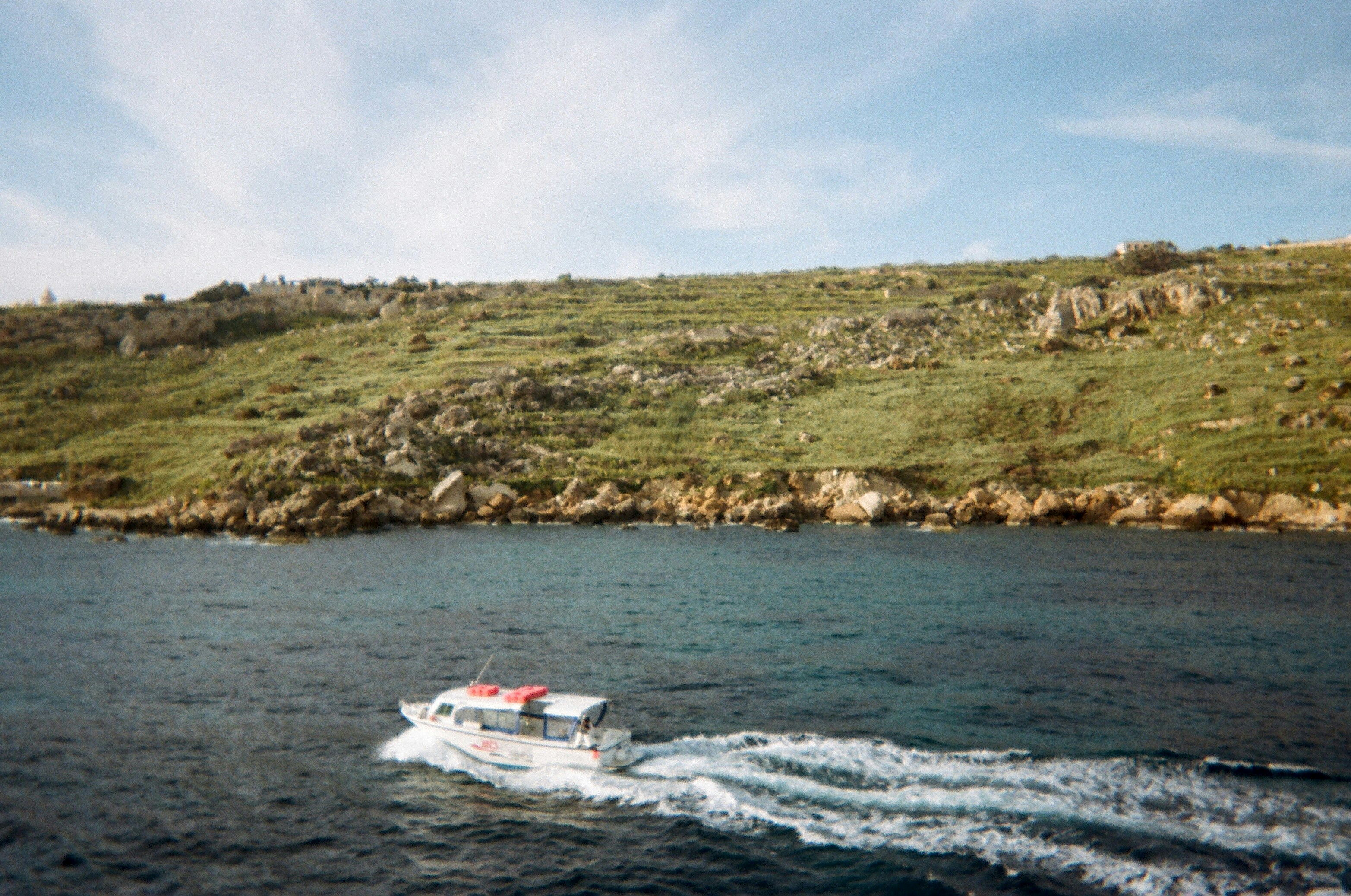A small boat traveling on a large body of water