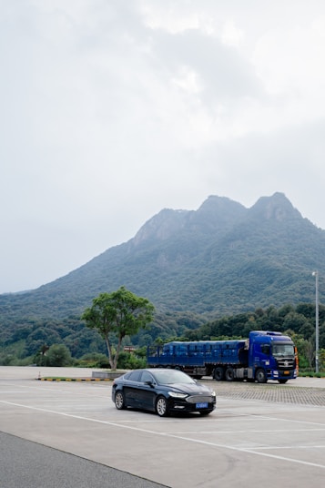 A car parked in a parking lot with a mountain in the background