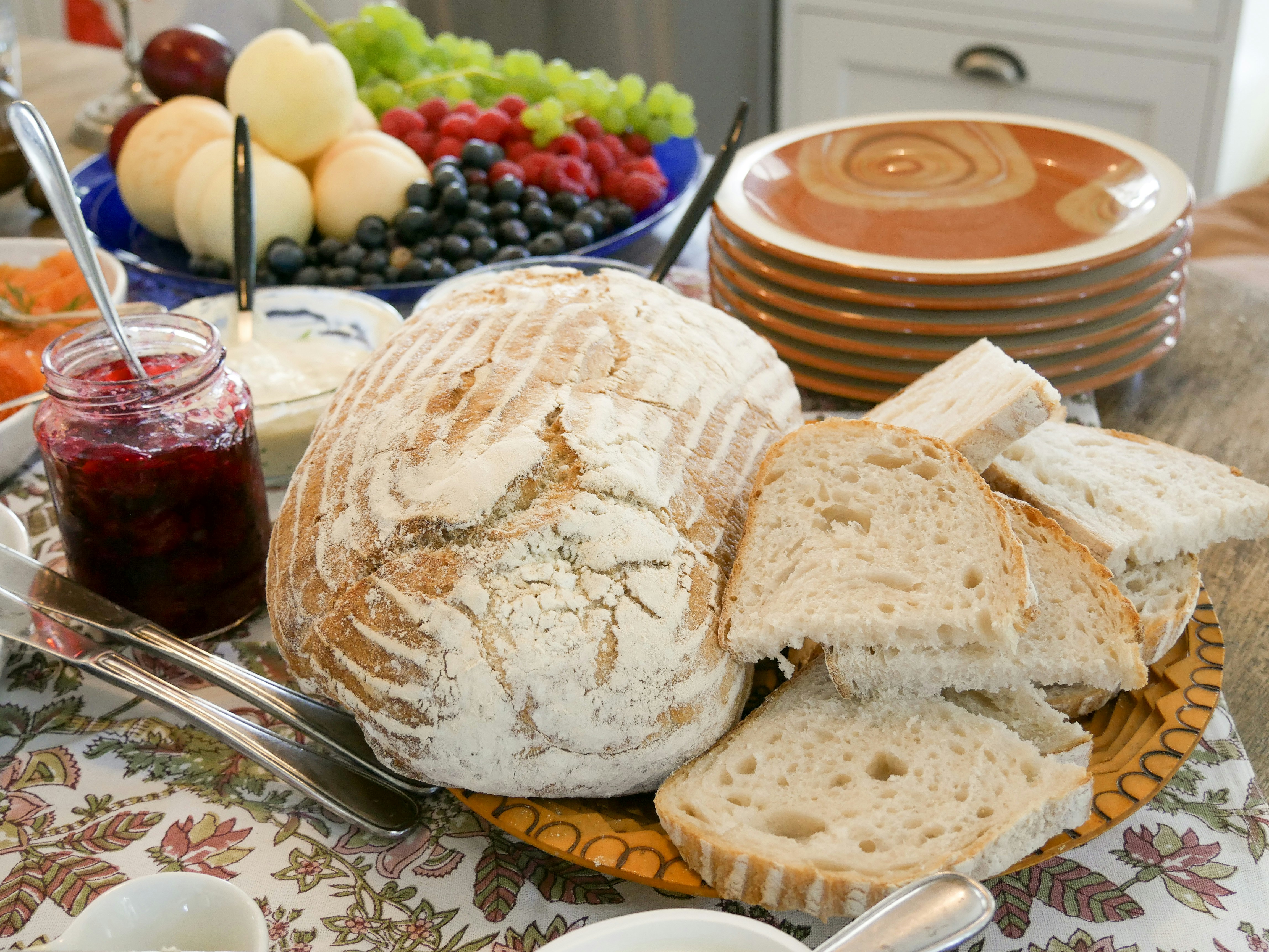 A harvest table set with seasonal food for a gratitude feast