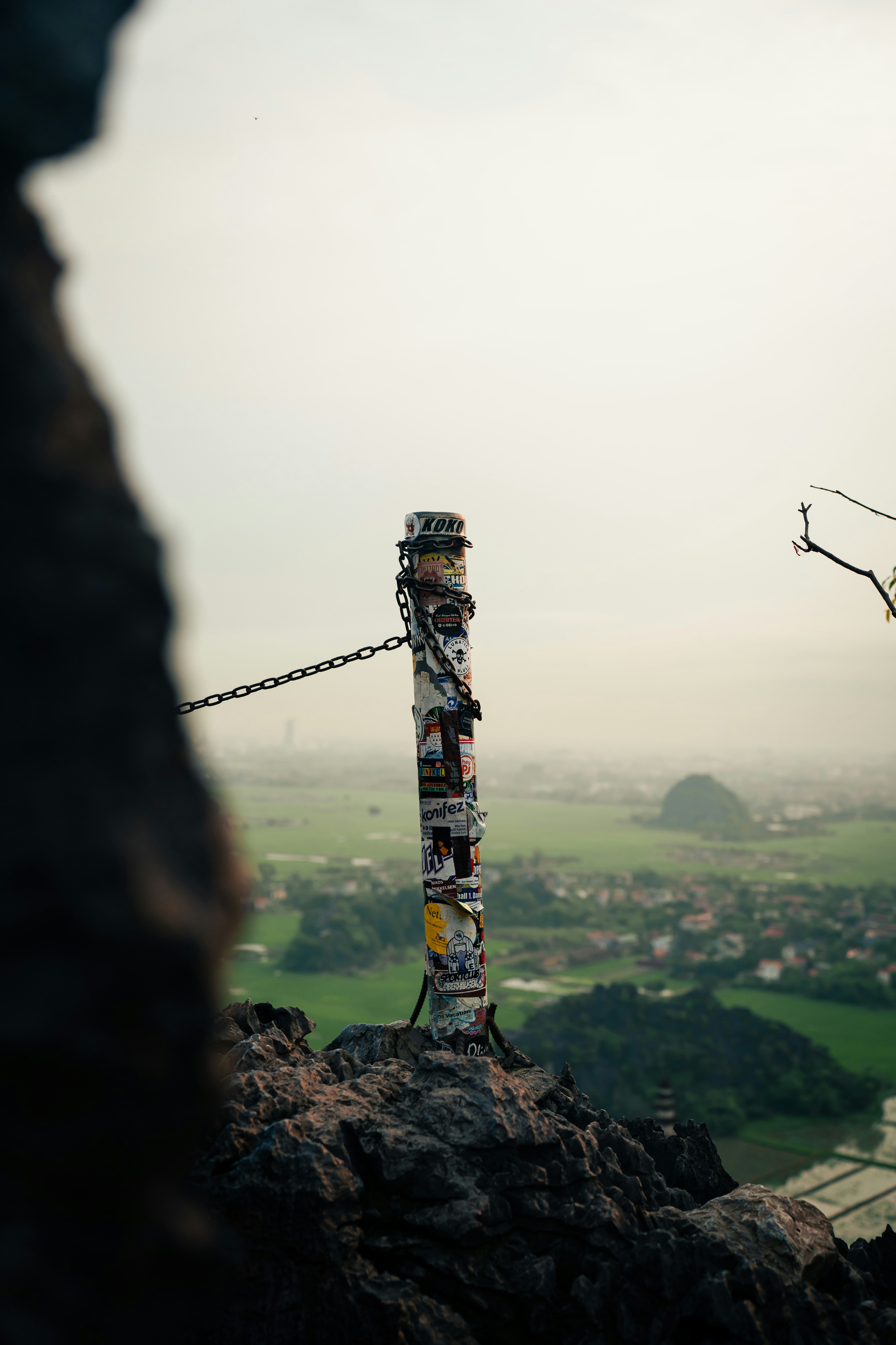A pole on top of a mountain with a sky background