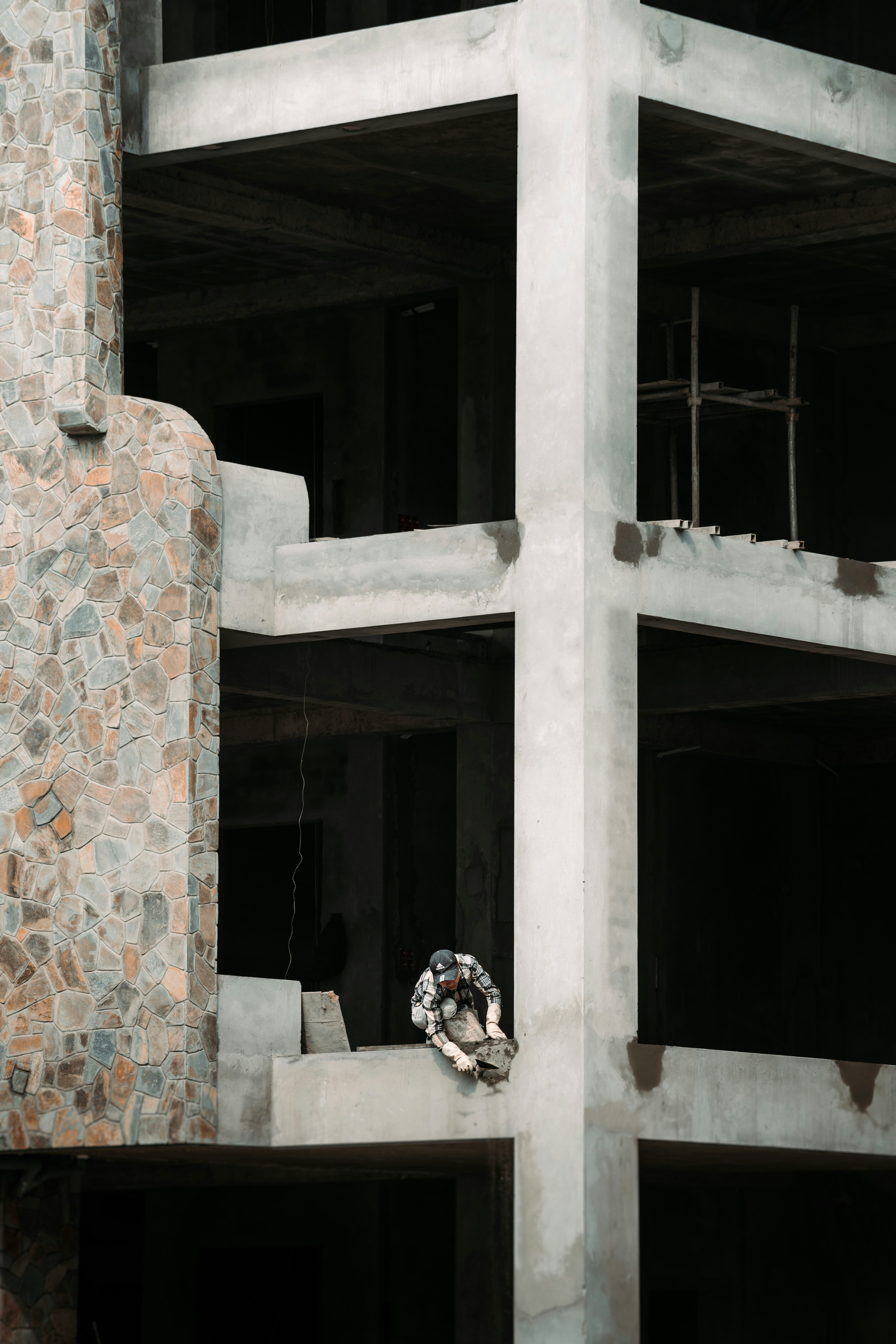 A building under construction with a clock on the side of it photo